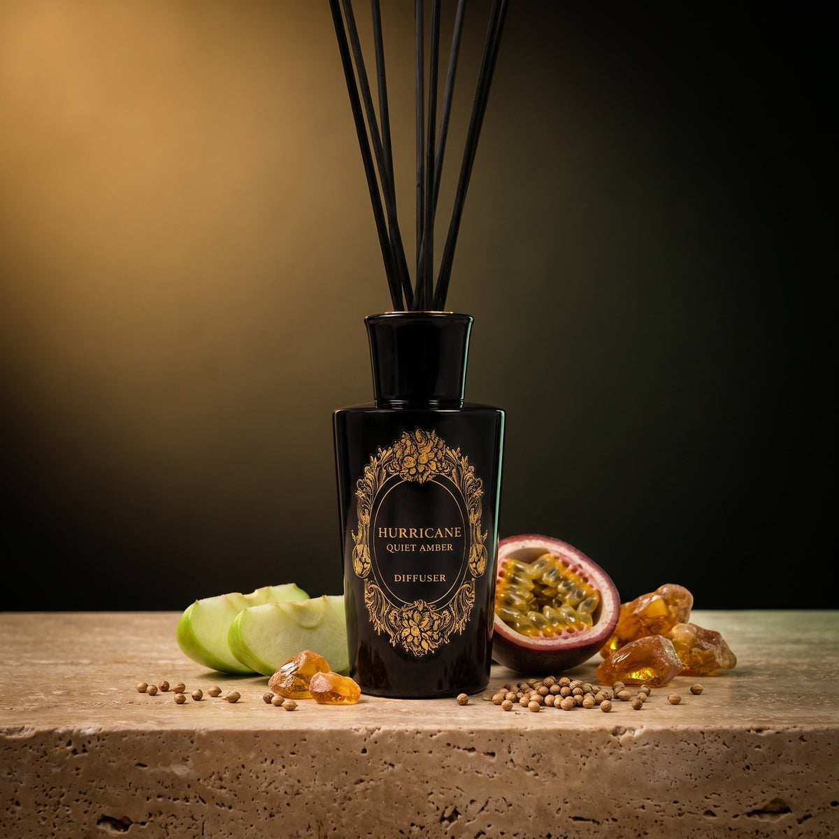 HURRICANE Quiet Amber reed diffuser: a black bottle with a gold oval label, black reeds and its notes around it.